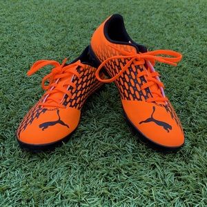 Neon Orange Puma Turf Cleats.